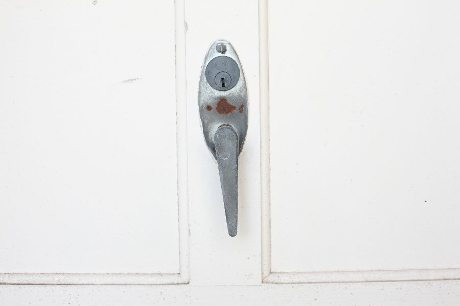A close-up of a garage door lock